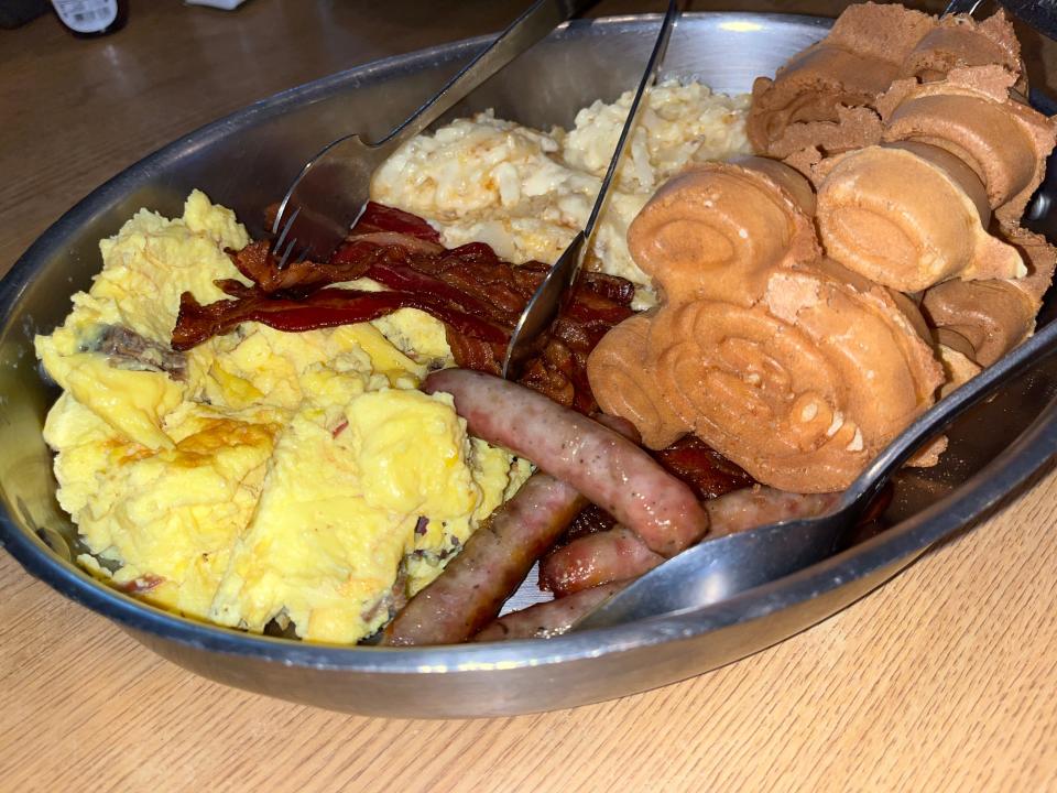 sausage, eggs, and mickey waffles in a metal container at trail's end