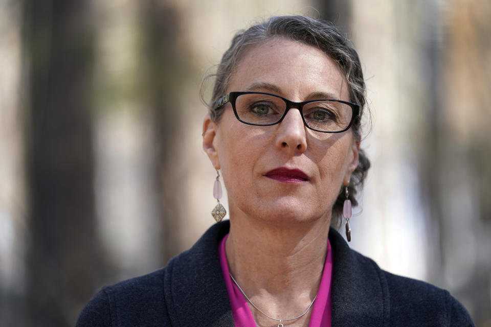 Susanna Schmitt Williams poses at her home in Chapel Hill, N.C., Thursday, Feb. 25, 2021. Williams, the former chief of the Carrboro Fire Department, considered suicide after enduring harassment in her department despite becoming chief. Advocates for female firefighters say their struggles are part of a larger trend, as evidenced by recent gender discrimination lawsuits against fire departments in Illinois, Virginia, and Texas. (AP Photo/Gerry Broome)