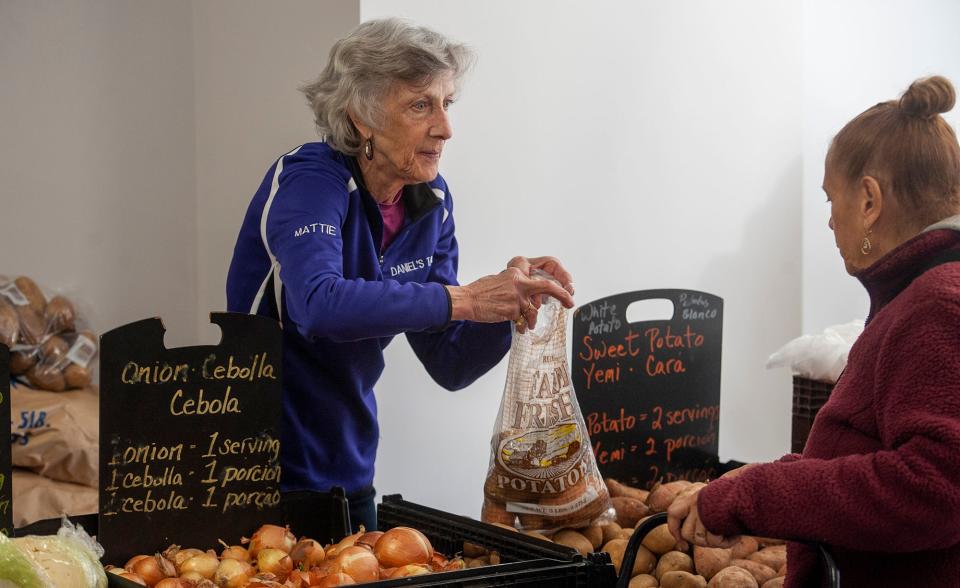 Mattie Schadt, a volunteer from Ashland, helps out with the farmers market at Daniel's Table on Park Street, April 24, 2024.