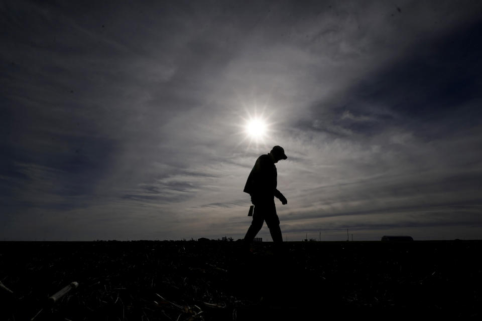 Ben Zellner walks back to his truck after checking on an irrigation well on his farm Thursday, Jan. 5, 2023, near Marienthal, Kan. Lawmakers are looking to take up groundwater issues in western Kansas in the upcoming session as the Kansas Water Authority is urging stricter usage measures to try to slow the steady decline of water levels in the Ogallala Aquifer. (AP Photo/Charlie Riedel)