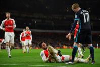Football Soccer - Arsenal v Manchester City - Barclays Premier League - Emirates Stadium - 21/12/15 Arsenal's Olivier Giroud lies injured as Manchester City's Kevin De Bruyne looks on Reuters / Dylan Martinez Livepic