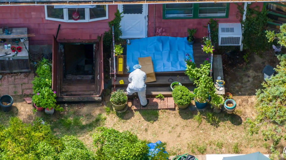 A police Investigator works in the backyard of Gilgo Beach murders suspect Rex Heuermann's home in Massapequa Park, on New York's Long Island, on July 14, 2023. / Credit: J. Conrad Williams Jr./Newsday RM via Getty Images