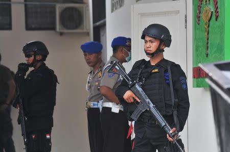 Indonesian security forces stand guard at the hospital where a body believed to be that of the country's most-wanted militant, Santoso, who was killed in a clash with security forces, is lying in Palu, Central Sulawesi, Indonesia July 19, 2016 in this photo taken by Antara Foto. Antara Foto/Fiqman Sunandar/ via REUTERS