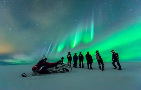 People looking at the Northern Lights