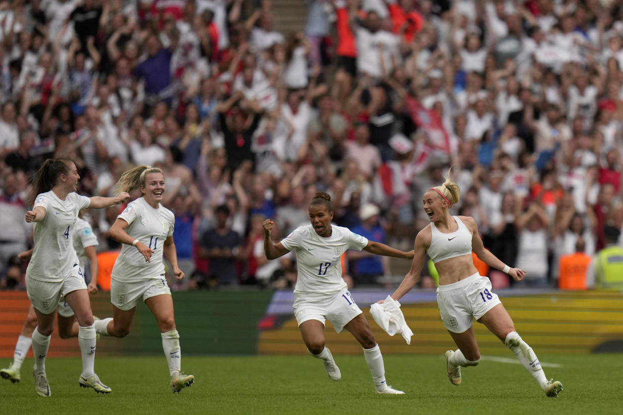 England's Chloe Kelly, right, celebrates after scoring her side's second goal during the Women's Euro 2022 final soccer match between England and Germany at Wembley stadium in London, Sunday, July 31, 2022. (AP Photo/Alessandra Tarantino)