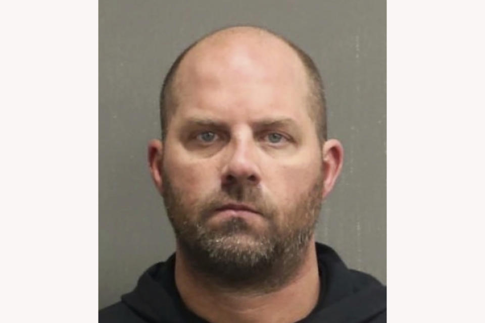 This booking photo released by the Metropolitan Nashville Police Department shows Harry Jerome Barker, also known as Jay Barker, on Saturday, Jan. 15, 2022. Tennessee authorities say the former Alabama quarterback was arrested on a felony domestic violence charge. The 49-year-old is married to country music singer Sara Evans and was booked into a Nashville jail early Saturday morning. (Metropolitan Nashville Police Department via AP)