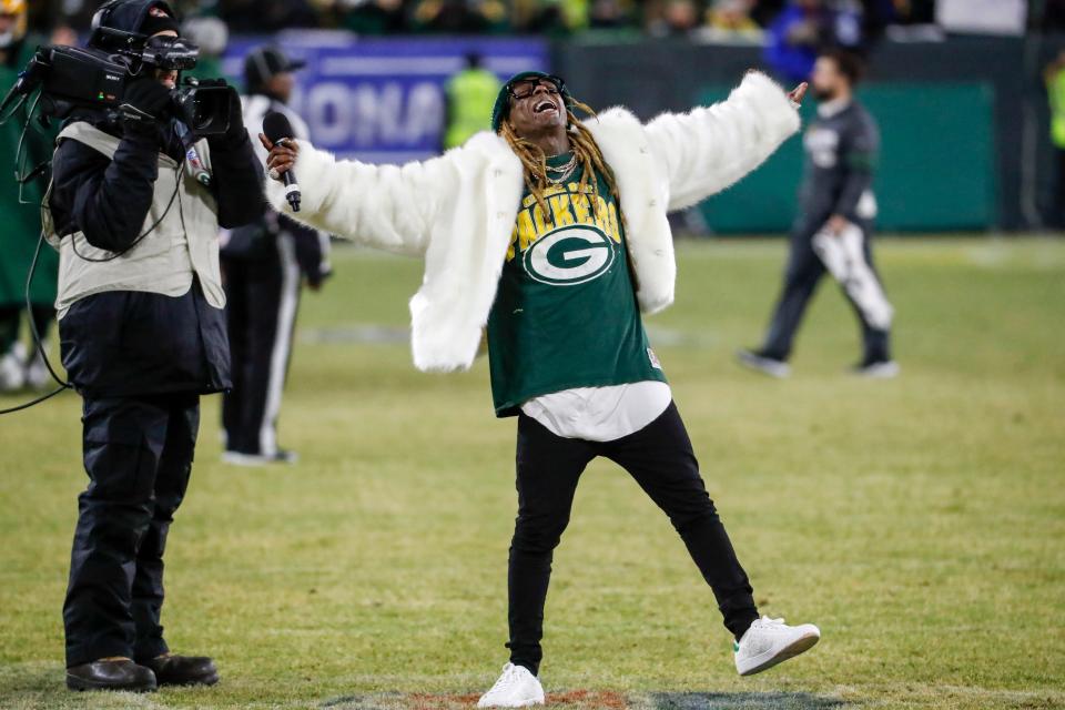 Rapper Lil Wayne sings during a break of the Packers' NFC divisional playoff game on Jan. 12, 2020, at Lambeau Field. Lil Wayne is a diehard Packers fan and made two songs about the team.