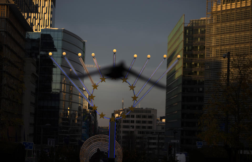 A bird flies in front of a menorah outside EU headquarters in Brussels, Saturday, Dec. 19, 2020. The European Union and the United Kingdom were starting a "last attempt" to clinch a post-Brexit trade deal, with EU fishing rights in British waters the most notable remaining obstacle to avoid a chaotic and costly changeover on New Year. (AP Photo/Virginia Mayo)