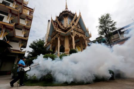 A city worker fumigates the area to control the spread of mosquitoes at a temple in Bangkok, Thailand, September 14, 2016. REUTERS/Chaiwat Subprasom