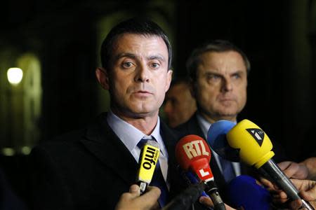 French Interior Minister Manuel Valls (L) and Christian Flaesch, director of the Paris judiciary police, attend a news conference at the headquarters of the Paris police November 21, 2013. REUTERS/Gonzalo Fuentes