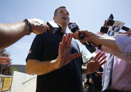 Former Attorney General John Swallow speaks to the media after being booked at the Salt Lake County Metro Jail in South Salt Lake City July 15, 2014. REUTERS/Jim Urquhart