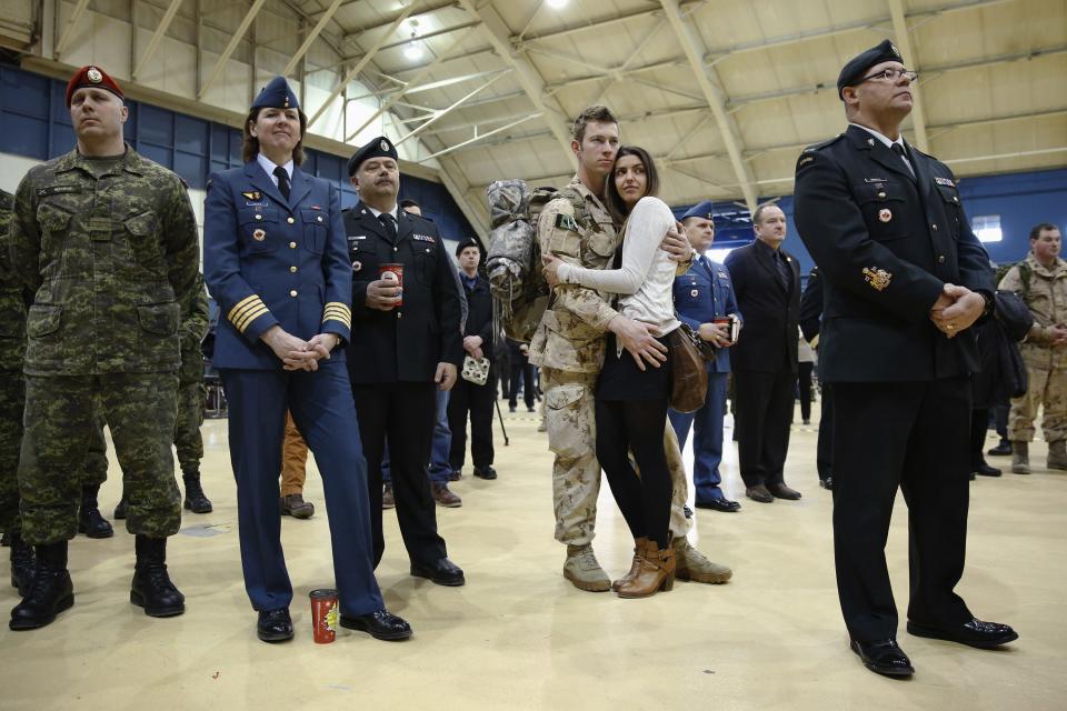 Canadian Army Master Corporal Anthony Alliot embraces Sarah Tooth during a ceremony after arriving from Afghanistan, in Ottawa