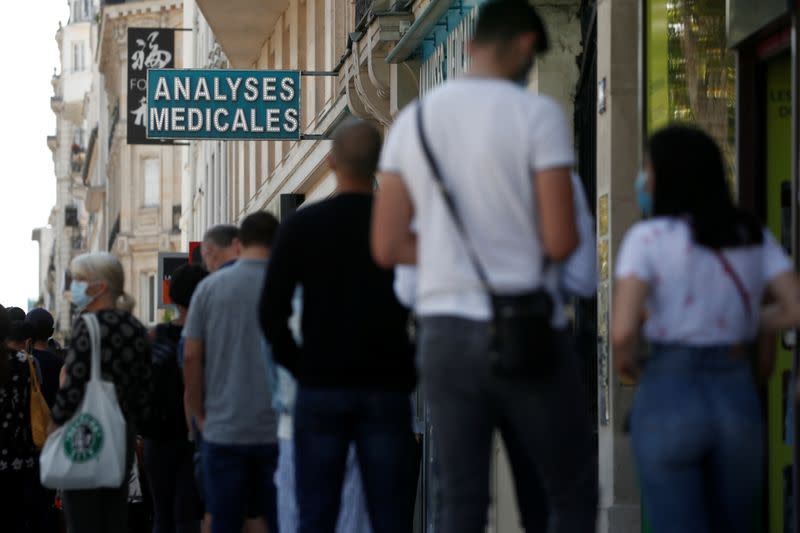 People queue to enter a laboratory to get tested for the coronavirus disease (COVID-19) in Neuilly-sur-Seine, near Paris