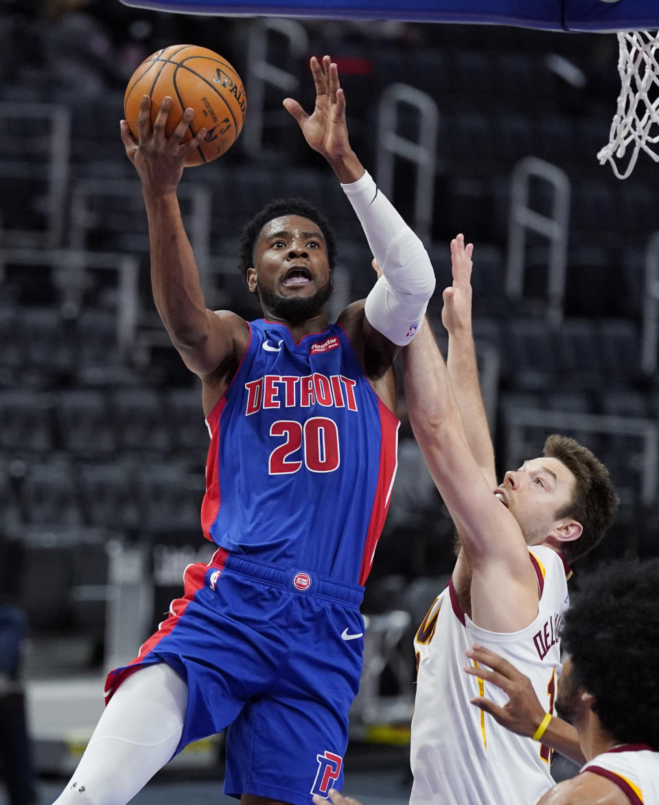 Detroit Pistons guard Josh Jackson (20) makes a layup as Cleveland Cavaliers guard Matthew Dellavedova defends during the second half of an NBA basketball game, Monday, April 19, 2021, in Detroit. (AP Photo/Carlos Osorio)