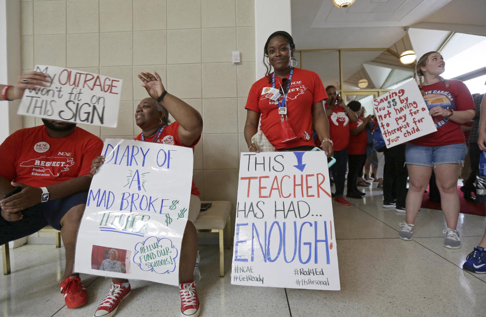<p>Teachers gather outside the Senate and House chambers during a teachers rally at the General Assembly in Raleigh, N.C., Wednesday, May 16, 2018. (Photo: Gerry Broome/AP) </p>