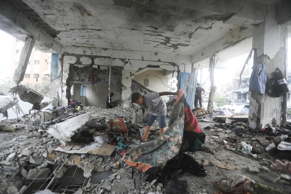 Palestinians look at the aftermath of the Israeli strike on a U.N.-run school that killed dozens of people in the Nusseirat refugee camp in the Gaza Strip, Thursday, June 6, 2024. The Israeli military said that Hamas militants were operating from within the school. (AP Photo/Ismael Abu Dayyah)