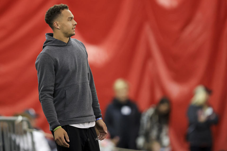 Former Cincinnati quarterback Desmond Ridder watches the game action from the field during an NCAA football intrasquad scrimmage, Saturday, April 9, 2022, in Cincinnati. (AP Photo/Aaron Doster)