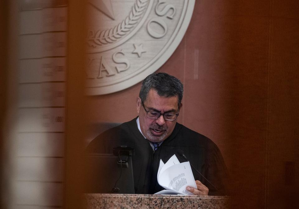 County Court At Law 7 judge Ruben Morales reviews documents during a hearing on April 22, 2024 for 142 migrants arrested in connection with a confrontation with Texas National Guard Troops at Gate 36 on the Rio Grande.