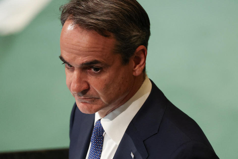 Prime Minister Kyriakos Mitsotakis stands to speak.