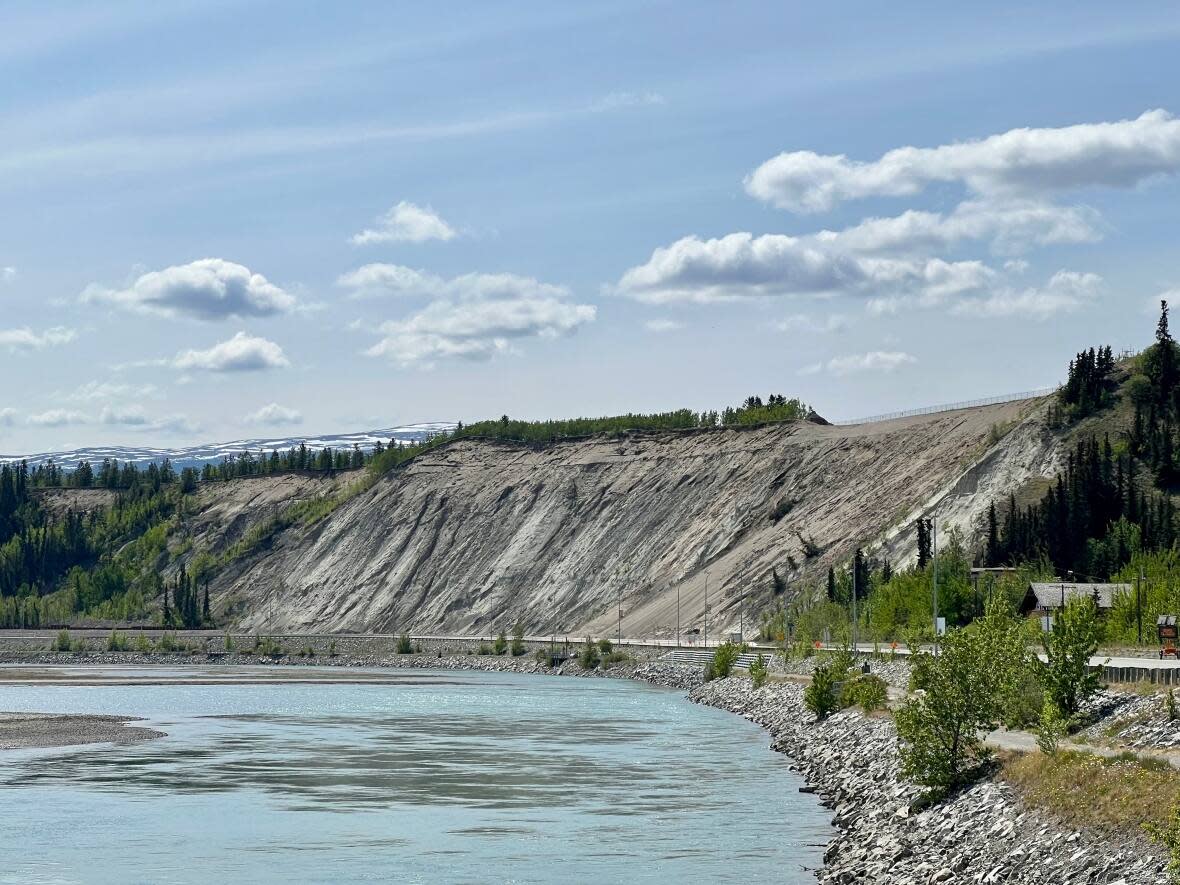 A view of the Whitehorse escarpment alongside Robert Service Way on Sunday. The road is closed again on Monday after slope sensors detected more movement and another small slide on the escarpment on Sunday. (Kanina Holmes/CBC - image credit)