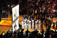 MIAMI, FL - OCTOBER 30: The Miami Heat watch as their 2012 NBA Championship banner is raised during a ceremony prior to the game against the Boston Celtics on October 30, 2012 at American Airlines Arena in Miami, Florida. NOTE TO USER: User expressly acknowledges and agrees that, by downloading and/or using this Photograph, user is consenting to the terms and conditions of the Getty Images License Agreement. Mandatory Copyright Notice: Copyright 2012 NBAE (Photo by Garrett W. Ellwood/NBAE via Getty Images)