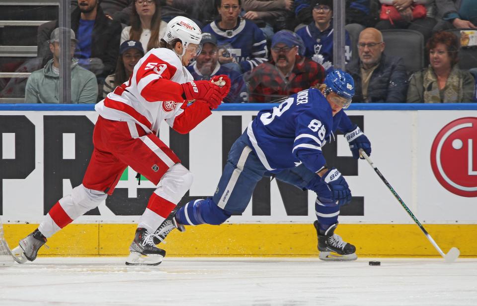 Red Wings defenseman Moritz Seider gets set up to trip the Maple Leafs' William Nylander during the first period on Saturday, Jan. 7, 2023, in Toronto.
