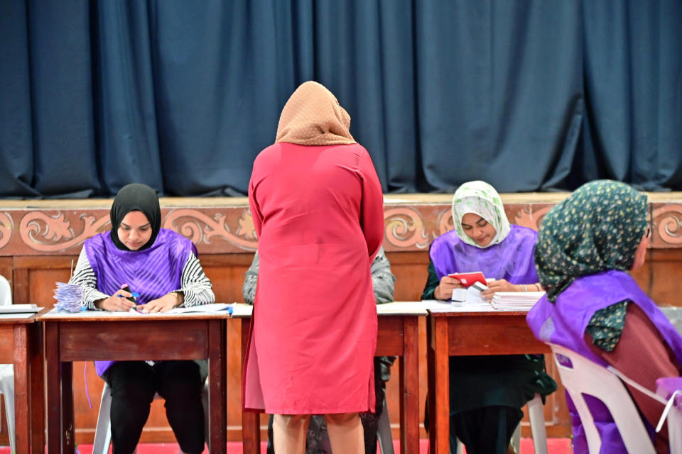 A woman casts her vote at a polling station in Male, India, Sunday, April 21, 2024. Maldivians are voting in parliamentary elections, in a ballot crucial for President Mohamed Muizzu, whose policies are keenly watched by India and China as they vie for influence in the archipelago nation. (AP Photo/Mohamed Sharuhaan)