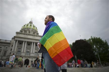 Steve Krout, 28, remains on the Pennsylvania State Capital steps following a rally with gay rights supporters after a ruling struck down a ban on same sex marriage in Harrisburg, Pennsylvania, May 20, 2014. REUTERS/Mark Makela