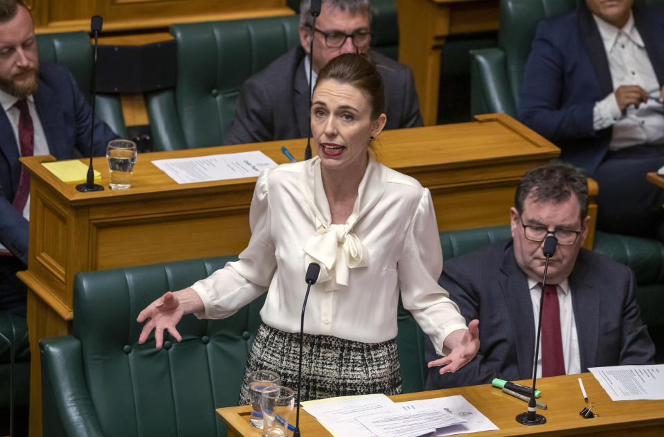 New Zealand's Prime Minister Jacinda Ardern moves a motion in the Parliament House in Wellington, New Zealand, to declare a climate emergency, Wednesday, Dec. 2, 2020. Joining more than 30 other countries around the world, New Zealand took the symbolic step of declaring a climate emergency. (Mark Mitchell/New Zealand Herald via AP)