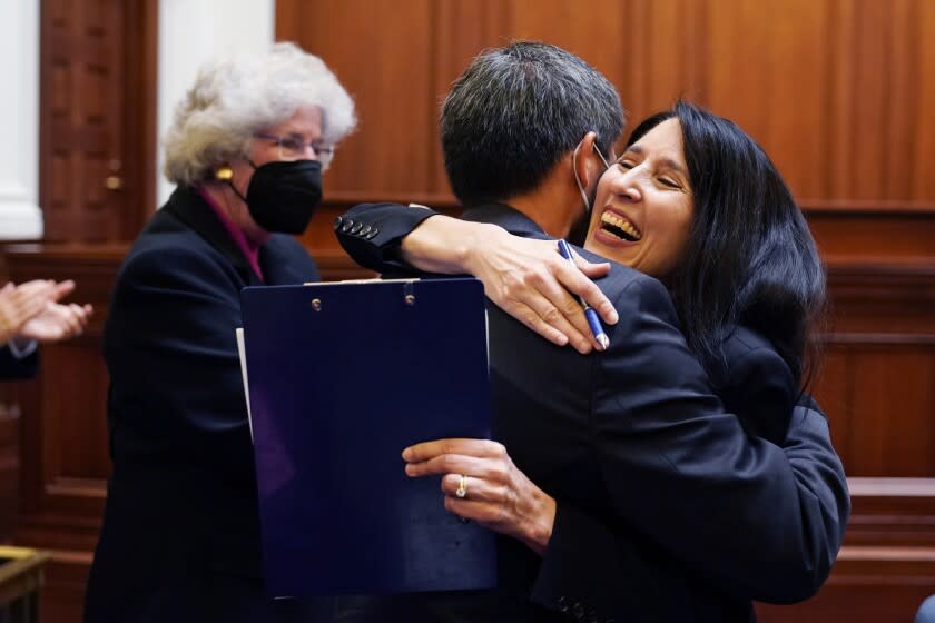 California Supreme Court Chief Justice nominee Patricia Guerrero is embraced by Justice Goodwin Liu after her nomination was confirmed by the Commission on Judicial Appointments in San Francisco, Friday, Aug. 26, 2022. Justice Guererro is set to replace Chief Justice Tani Cantil-Sakauye, who is retiring. She would be the first Latina to serve as California's Chief Justice. At left is Justice Carol Corrigan. (AP Photo/Eric Risberg, Pool)