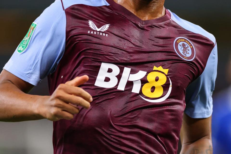 An Aston Villa men’s player playing in a soaked home kit against Everton   (Getty Images)