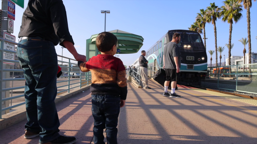 A man and a child await to board a Metrolink train in this undated promotional photo from Metrolink.