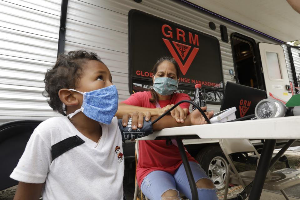 Angel Gabriel Recinos, 5, has his blood pressure taken by Mileydis Tamayo Salgado.