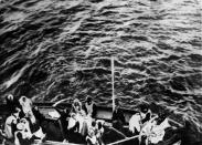 A boatload of survivors pulls alongside the Carpathia.