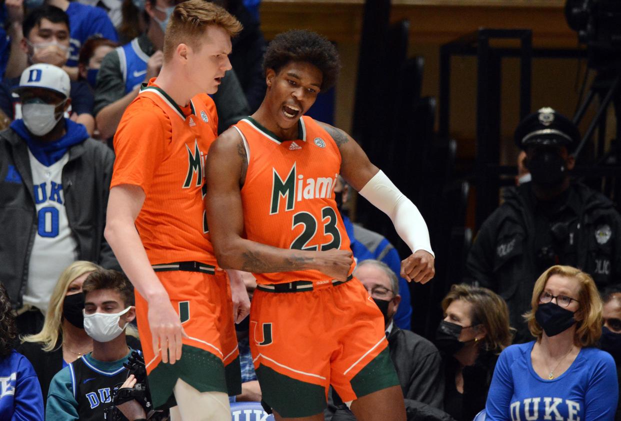 Miami guard Kameron McGusty (23) is greeted by teammate Sam Waardenburg after scoring against Duke during the Hurricanes' upset of the Blue Devils at Cameron Indoor Stadium on Jan. 8.