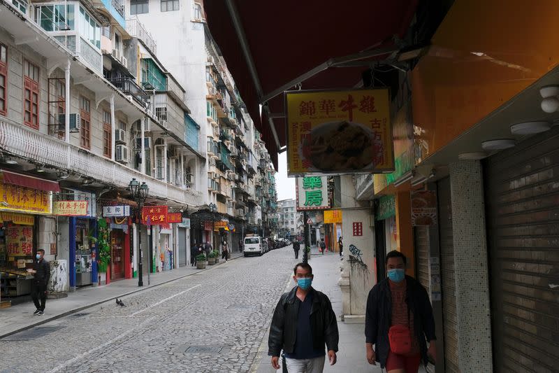 People wear masks as they walk near Ruins of St. Paul’s, following the coronavirus outbreak in Macau