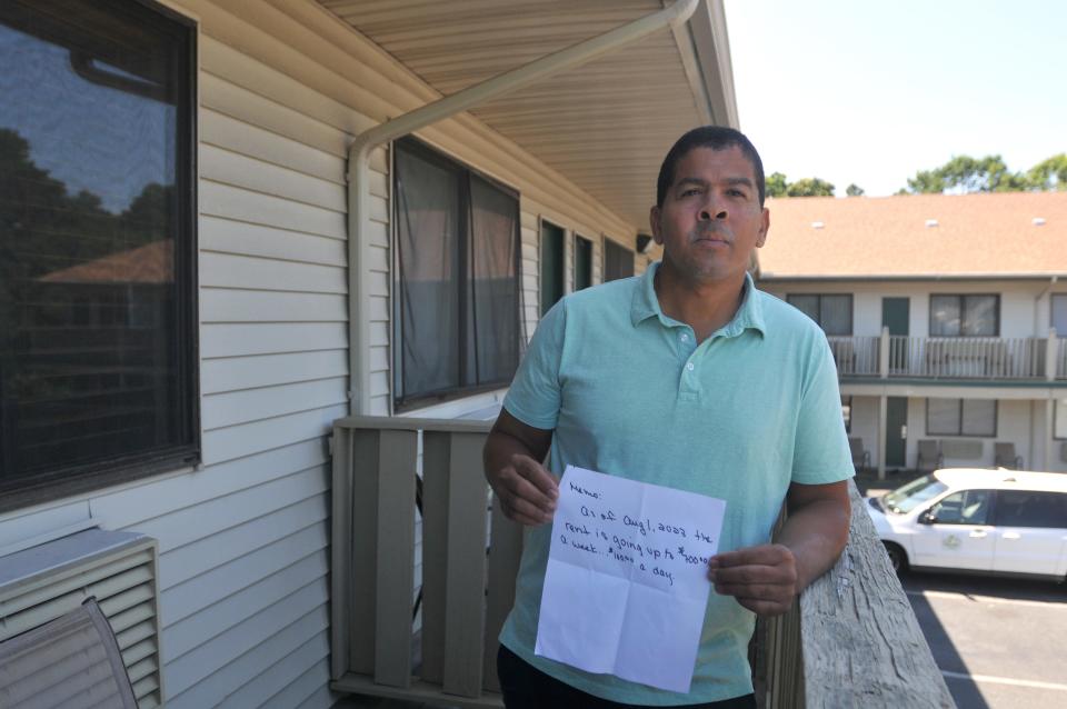 Ilio Perez holds the letter he received telling him the rent for his room at Yarmouth Resort in West Yarmouth was increasing from $300 to $700 a week. Perez, who has been living at the Main Street motel for about a month, shown in the photo a week ago, is going to crash in makeshift accommodations on Nantucket.