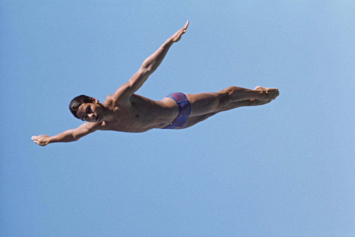 Olympic diver Greg Louganis of the United States performs a practice dive on 1st December 1984 in Los Angeles, California, United States. (Photo by Tony Duffy/Getty Images)