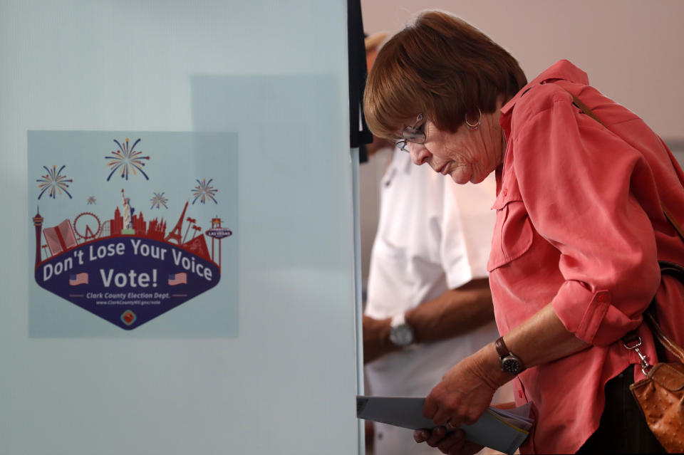 FILE -In this June 12, 2018, file photo, Christie Leavitt checks her sample ballot during primary election voting at the Green Valley Presbyterian Church in Henderson, Nev. I (Steve Marcus/Las Vegas Sun via AP, file)