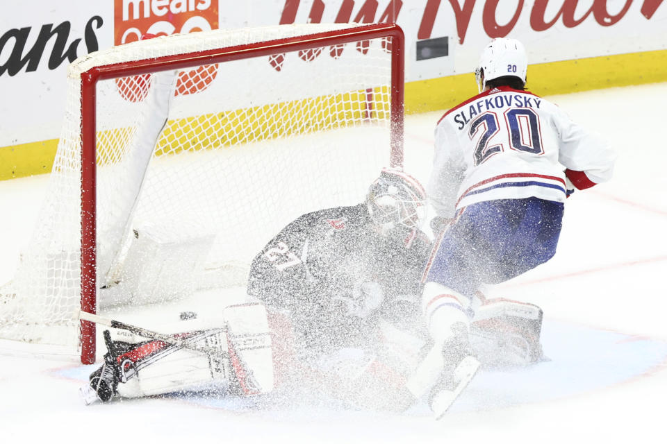 Montreal Canadiens left wing Juraj Slafkovsky (20) scores on Buffalo Sabres goaltender Devon Levi (27) during the shootout in an NHL hockey game Saturday, Dec. 9, 2023, in Buffalo, N.Y. (AP Photo/Jeffrey T. Barnes)