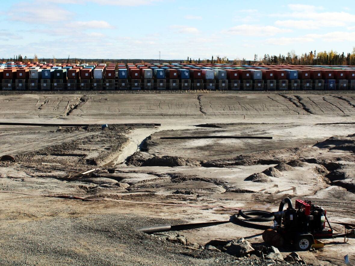 Rows of about 360 shipping containers at Yellowknife's Giant Mine site, filled with the toxic remnants of the mine's roaster building. Last November, the Giant Mine Remediation Project updated the estimated cleanup costs from $1 billion to $4.38 billion.  (Priscilla Hwang/CBC - image credit)