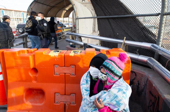 In this file photo from early 2021, after two years of waiting in Mexico under the Migrant Protection Protocols, a migrant from Guatemala and her two children, hope to be able to finally enter the U.S. at the Paso del Norte bridge in Juárez.
