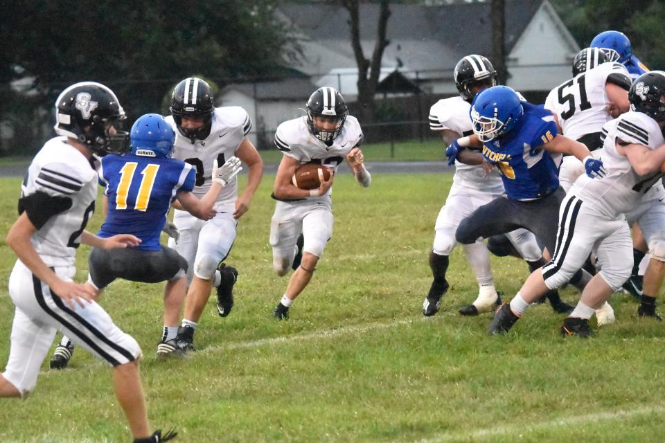 Springs Valley quarterback Kannon Chase charges through a big hole against Mitchell last season.