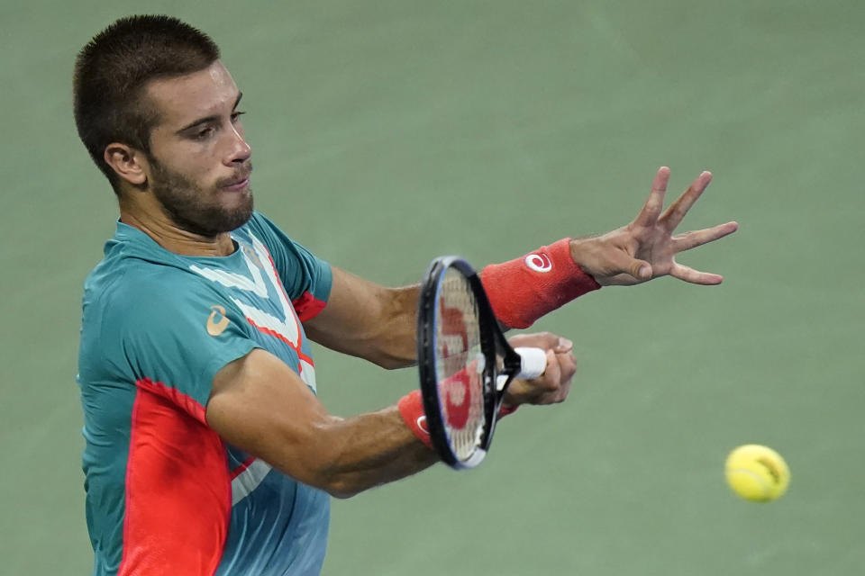 Borna Coric, of Croatia, returns a shot to Stefanos Tsitsipas, of Greece, during the third round of the U.S. Open tennis championships, Friday, Sept. 4, 2020, in New York. (AP Photo/Frank Franklin II)