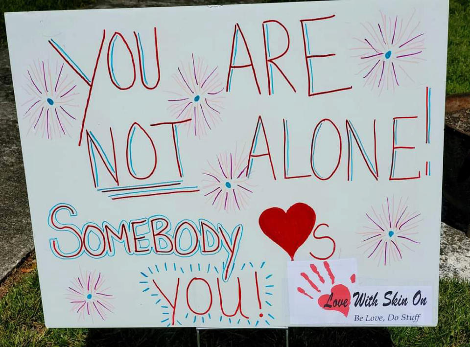 In this Oct. 2020 photo provided by Debra Ferrell, a sign with encouraging words stands in a neighbor's yard in Roanoke, Va., after Ferrell placed it there. For her 53rd birthday this year, Ferrell decided to give back with 53 acts of kindness, big and small, for people across the country. (Debra DC Ferrell via AP)