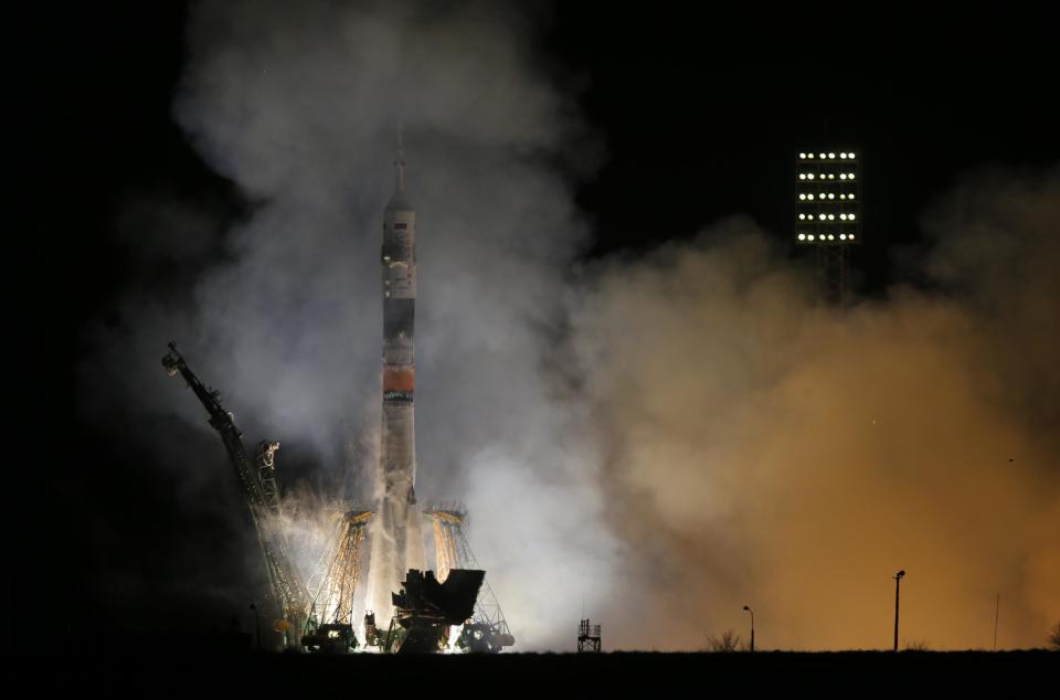 The Soyuz-FG rocket booster with Soyuz TMA-12M space ship carrying a new crew to the International Space Station (ISS) blasts off at the Russian leased Baikonur cosmodrome, Kazakhstan, Wednesday, March 26, 2014. The Russian rocket carries astronaut Steven Swanson, Russian cosmonauts Alexander Skvortsov and Oleg Artemyev. (AP Photo/Dmitry Lovetsky)