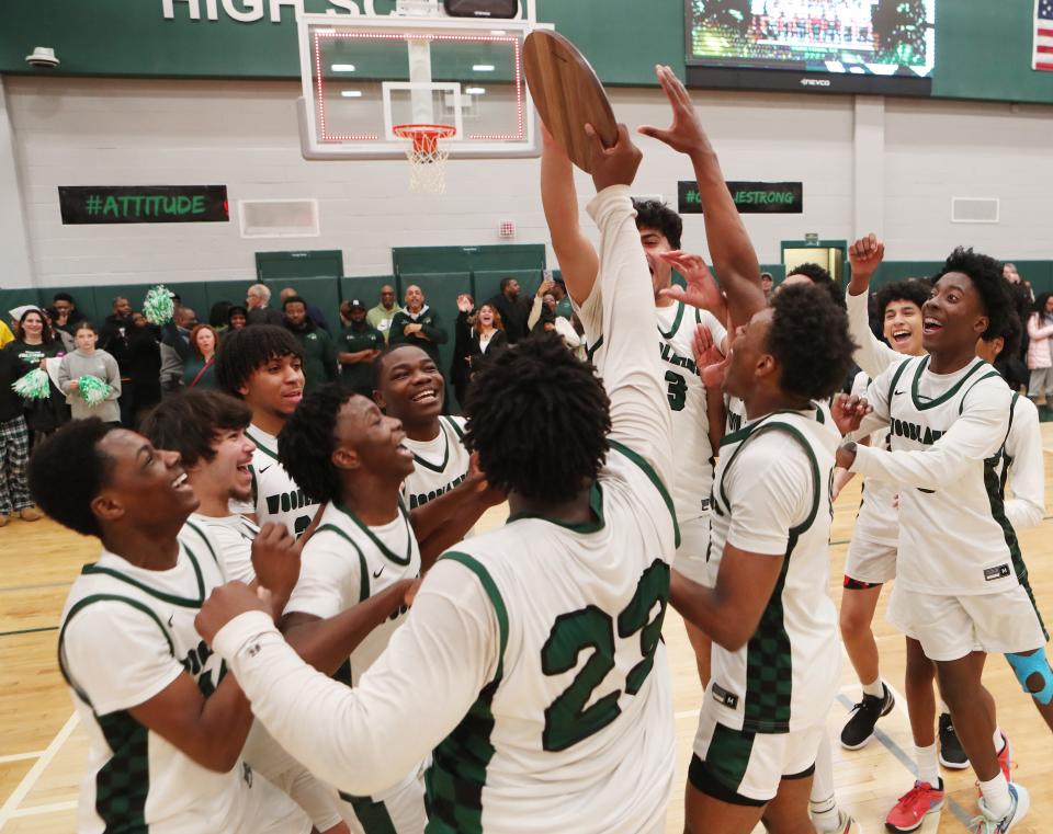 Woodlands players celebrate after defeating West Hempstead in overtime in the state Class B regional final at Yorktown High School March 9, 2024.