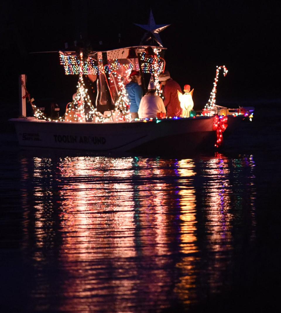 Boats gather in Snows Cut at the start of the Island of Lights Christmas Flotilla in Carolina Beach in 2016. This year's event is Dec. 3.