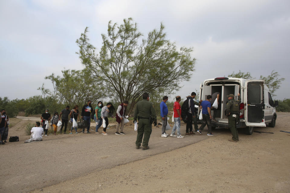 Migrants who had crossed the Rio Grande river into the United States are taken away by U.S. Border Patrol agents in Eagle Pass, Texas, Friday, May 20, 2022. As U.S. officials anxiously waited, many of the migrants crossing the border from Mexico on Friday were oblivious to a pending momentous court ruling on whether to maintain pandemic-related powers that deny a chance to seek asylum on grounds of preventing the spread of COVID-19. (AP Photo/Dario Lopez-Mills)