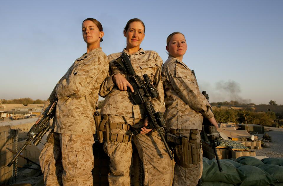 MUSA QALA, AFGHANISTAN - NOVEMBER 17: (SPAIN OUT, FRANCE OUT, AFP OUT) (L-R) Sargent Sheena Adams, 25, Hospital Corpsman Shannon Crowley,22, and Lance Corporal Kristi Baker,21, US Marines with the FET (Female Engagement Team) 1st Battalion 8th Marines, Regimental Combat team II pose at their forward operating base on November 17, 2010 in Musa Qala, Afghanistan. There are 48 women presently working along the volatile front lines of the war in Afghanistan deployed as the second Female Engagement team participating in a more active role, gaining access where men can't. The women, many who volunteer for the 6.5 month deployment take a 10 week course at Camp Pendleton in California where they are trained for any possible situation, including learning Afghan customs and basic Pashtun language. (Photo by Paula Bronstein/Getty Images)